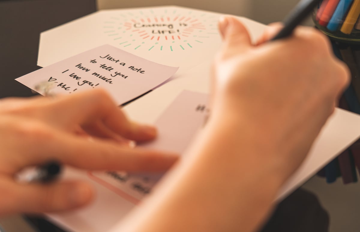 Person Writing On A Paper